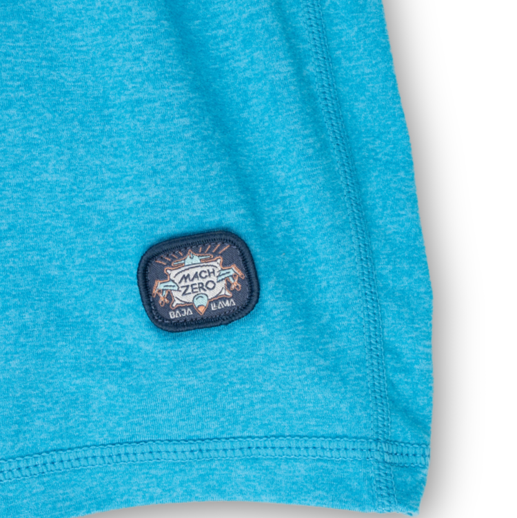 Close-up of a blue garment with a brand logo on a white background