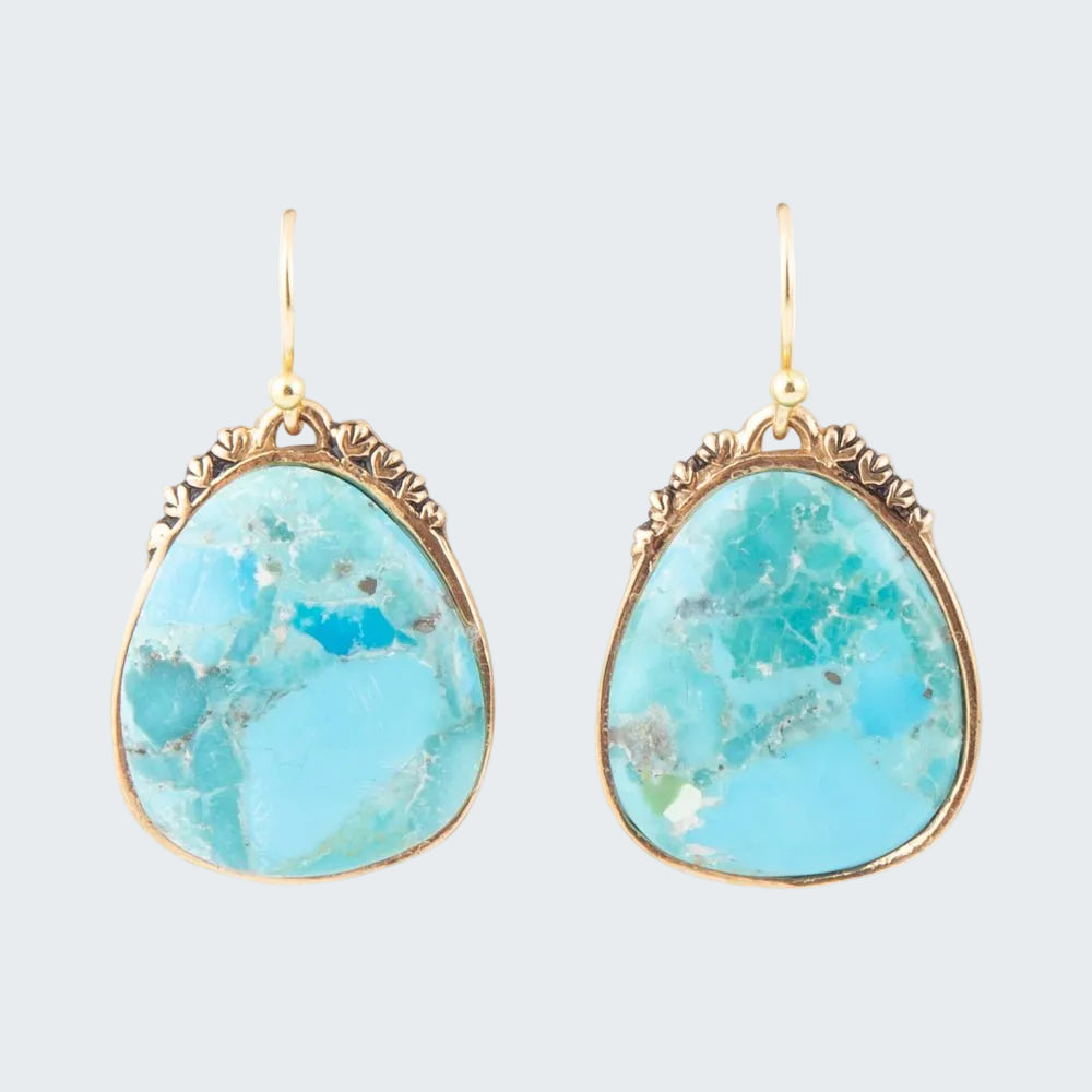 Turquoise stone earrings with gold frames on a white background