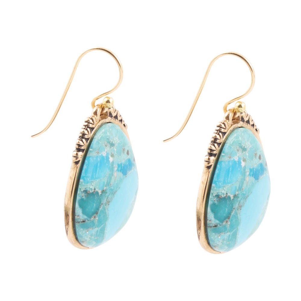 Turquoise earrings with gold accents on a white background