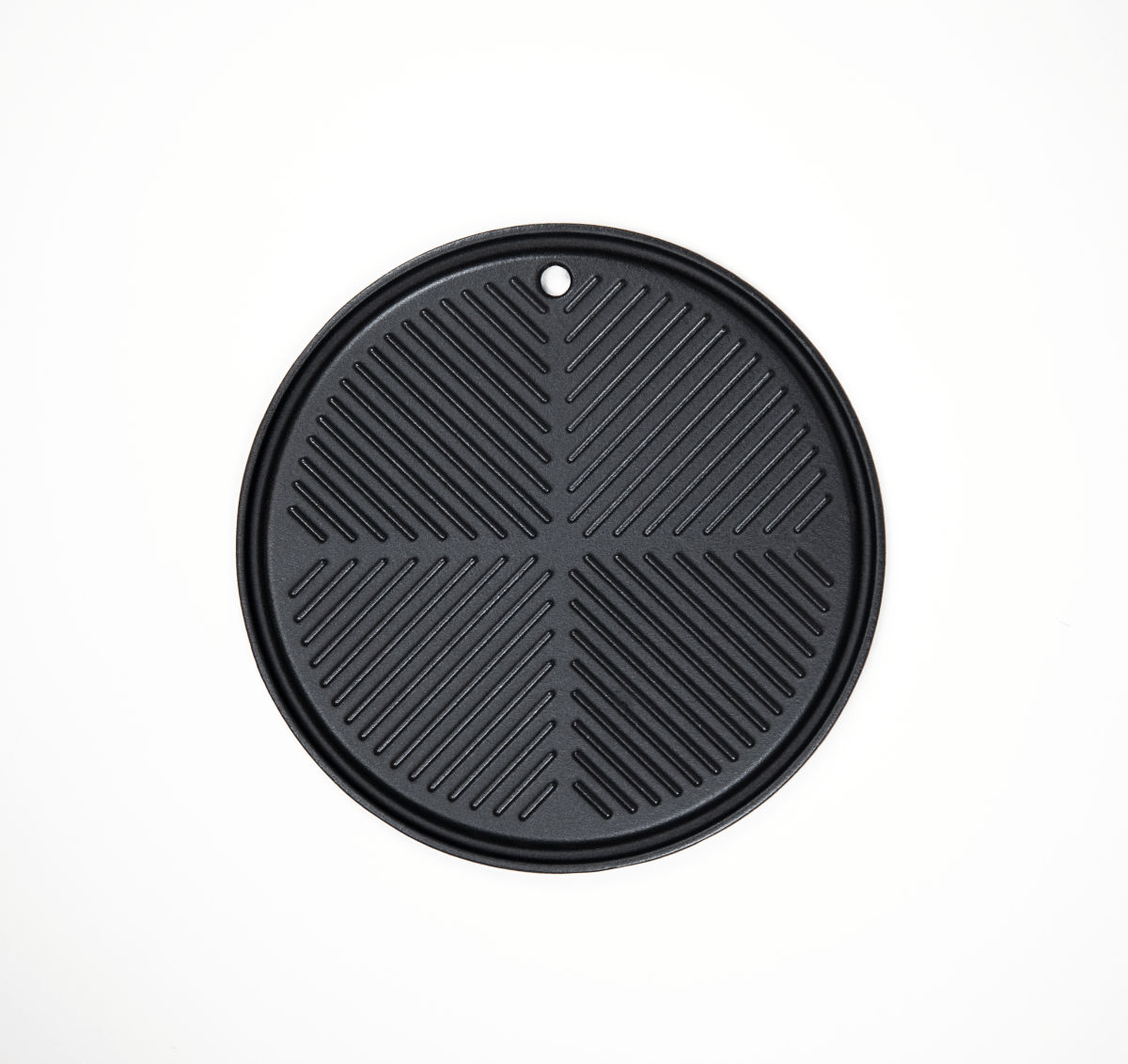 Black round grill pan with textured surface on a white background