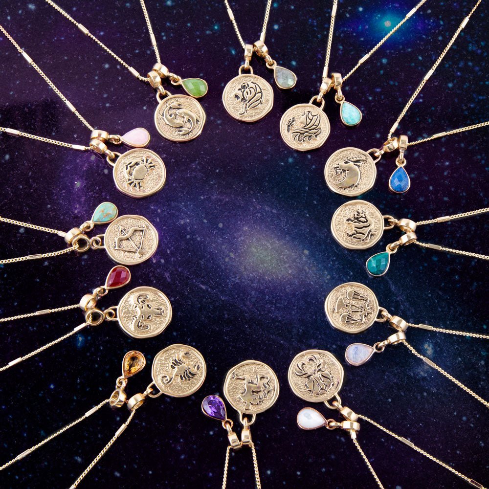 Gold necklaces with circular pendants against a starry night sky background