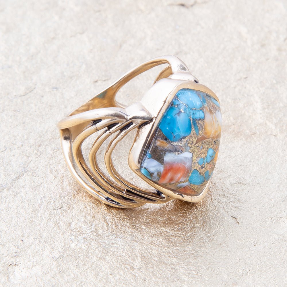 Ring with a blue stone on a sandy surface