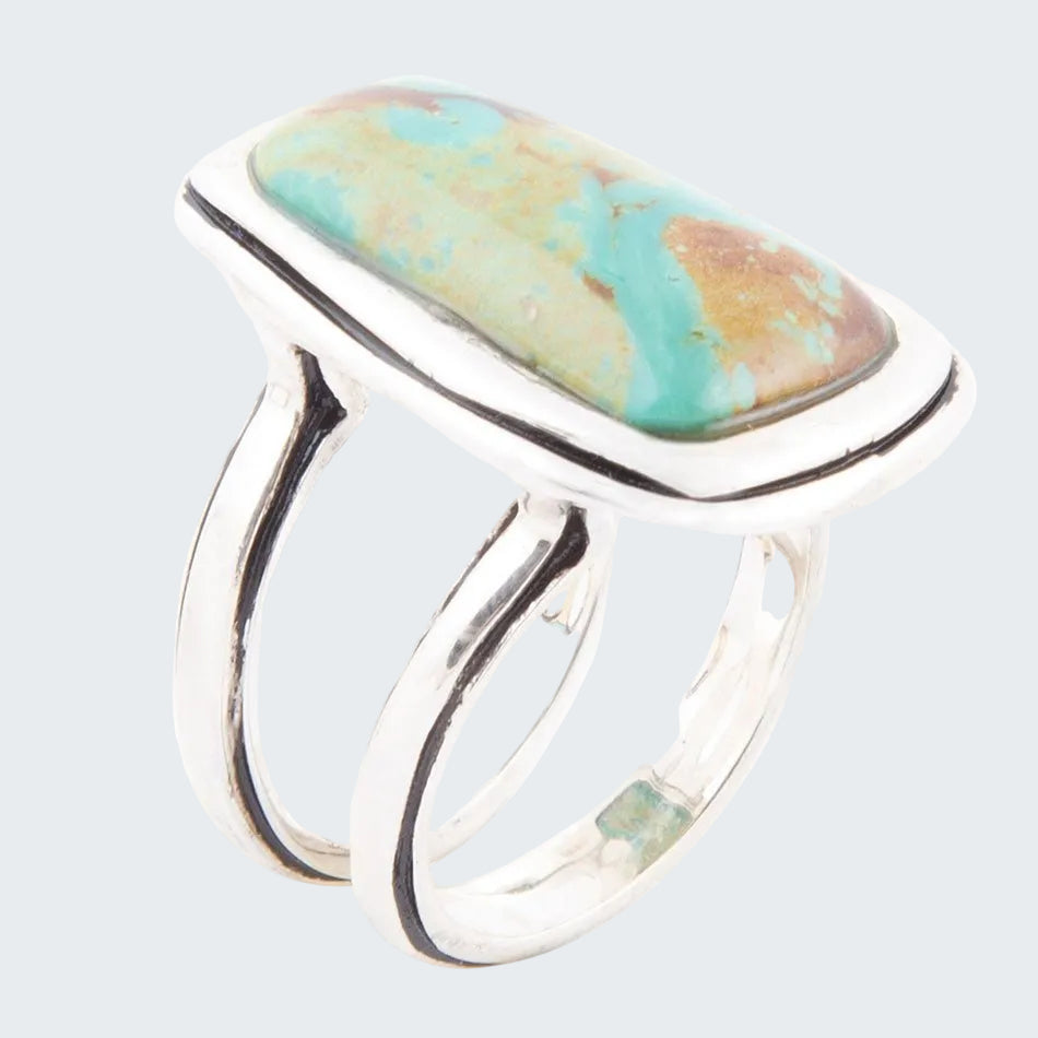 Silver ring with a colorful stone on a white background