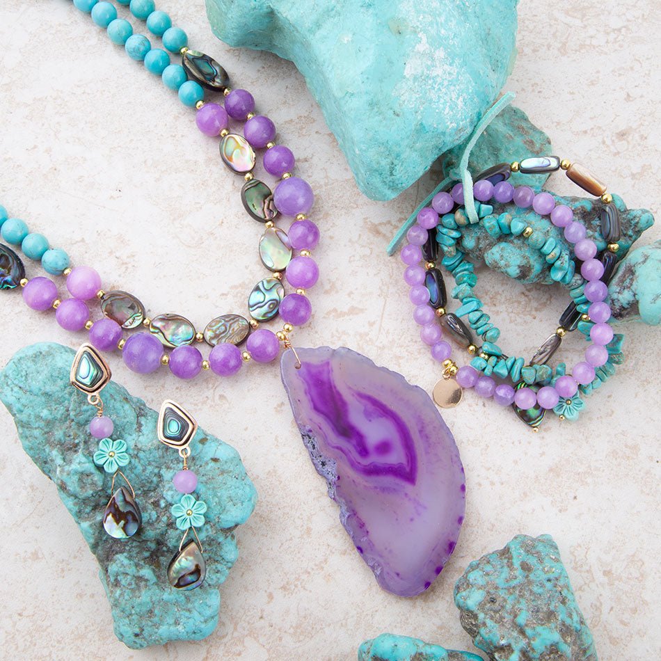 Jewelry set with turquoise and purple beads on a textured surface
