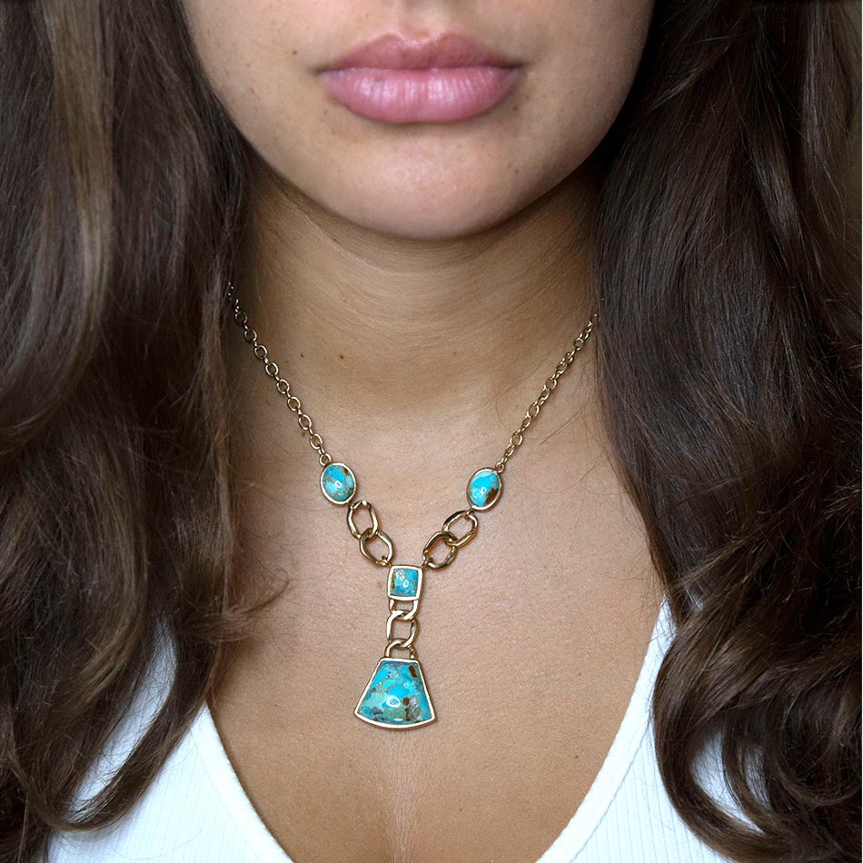 Necklace with turquoise pendants worn by a person