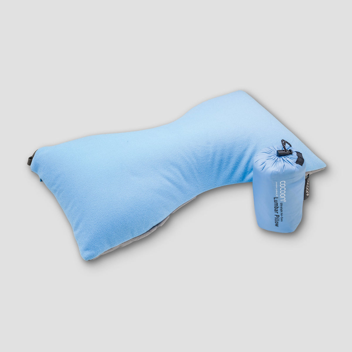 Blue travel pillow with packaging on a light gray background
