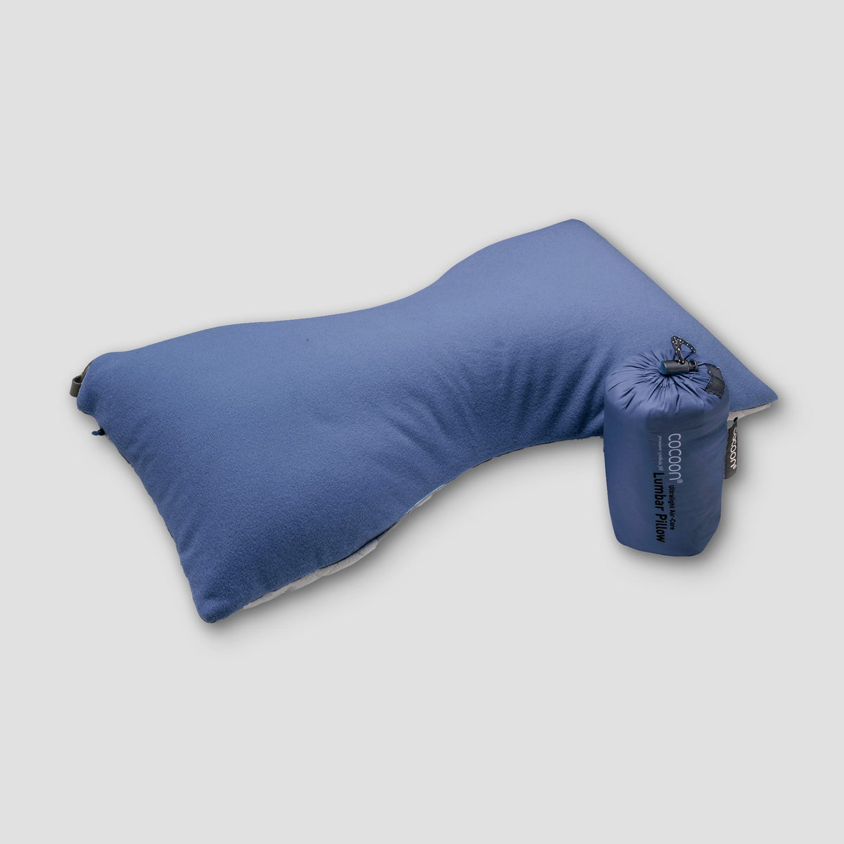 Blue travel pillow with packaging on a light gray background