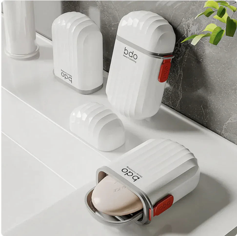 White soap holder with red accents on a bathroom counter, featuring the brand 'bdo'.