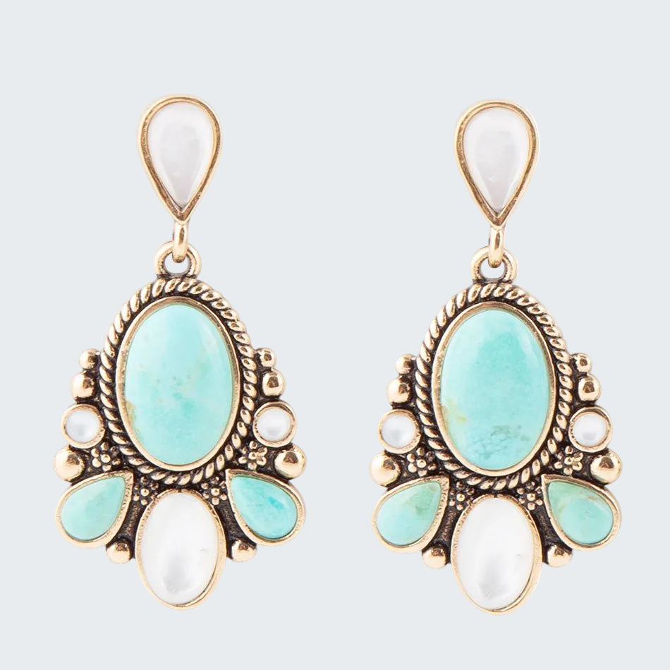 Pair of earrings with turquoise and white stones on a white background