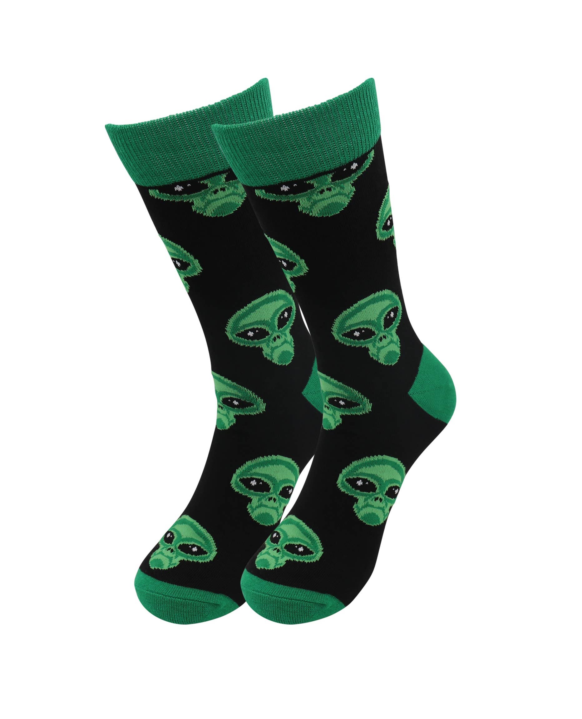 Black socks with green alien patterns on a white background