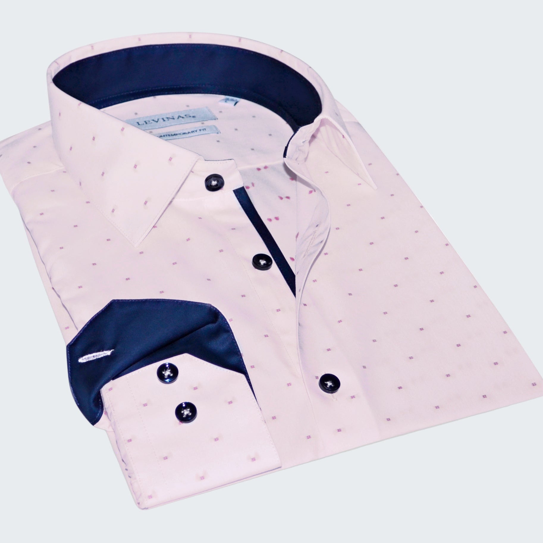 Pink dress shirt with white pattern and blue collar on a white background