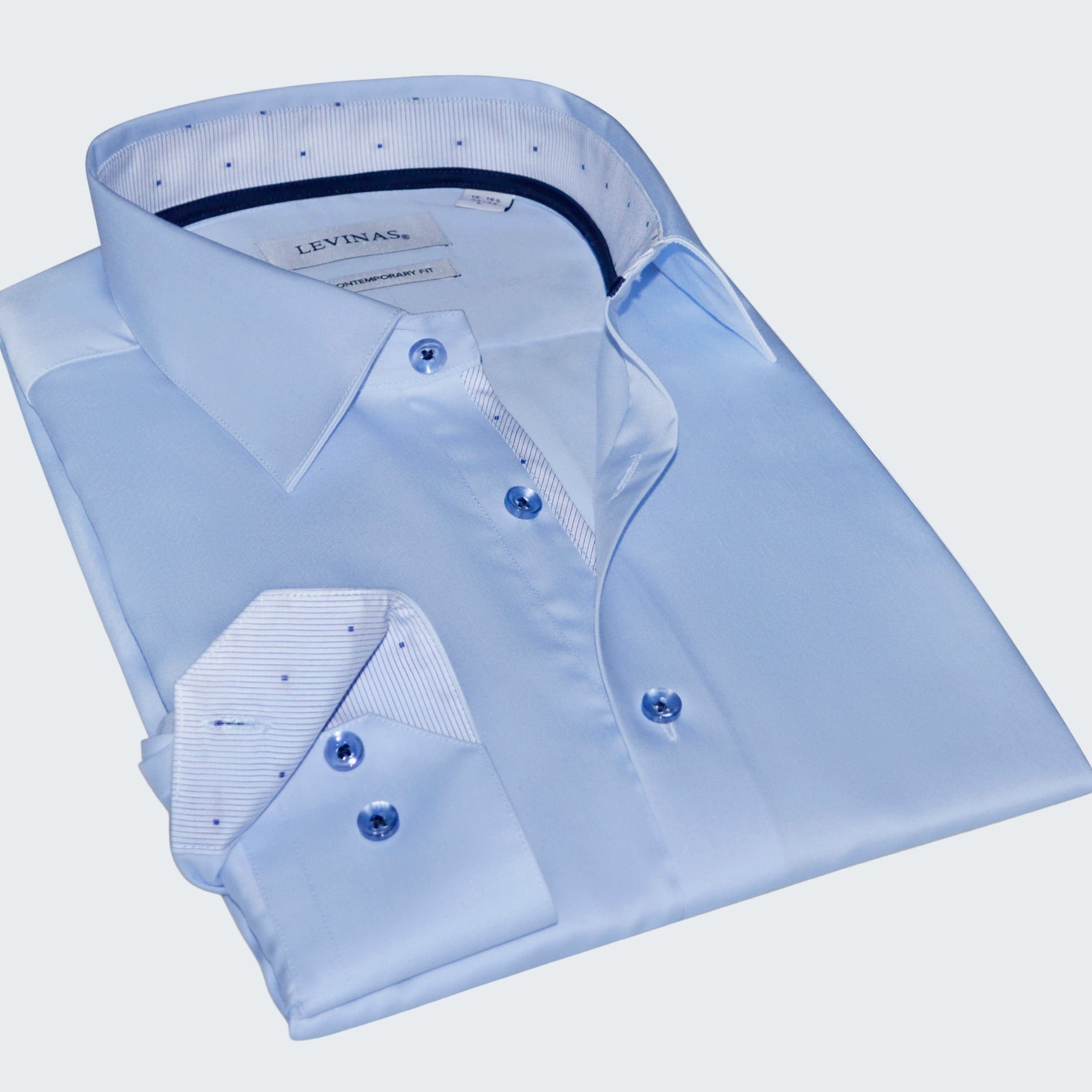 Folded light blue dress shirt with collar and cuffs on a white background