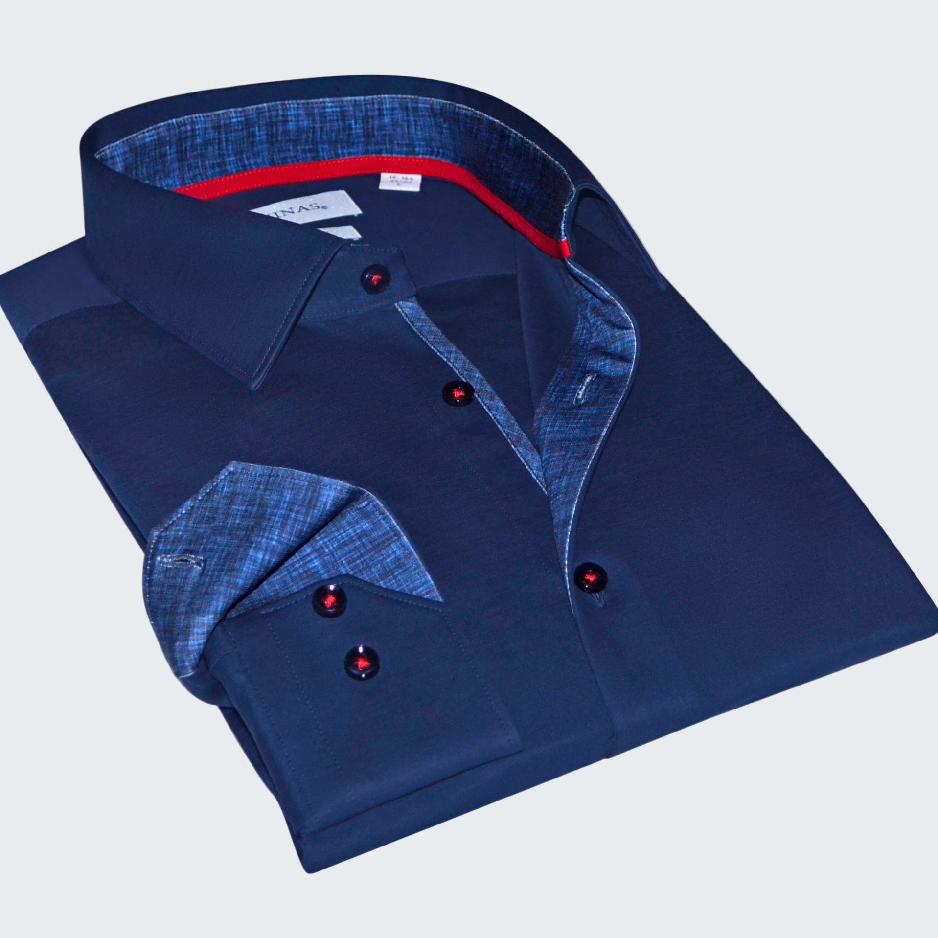Folded blue shirt with red buttons on a white background