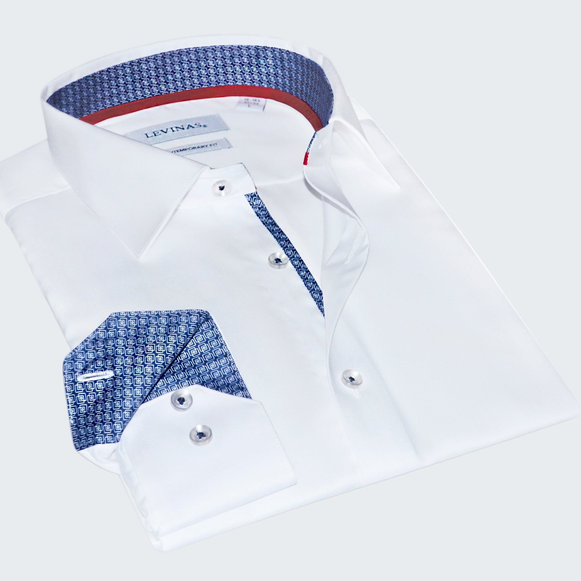 Folded white dress shirt with blue and red interior details on a white background