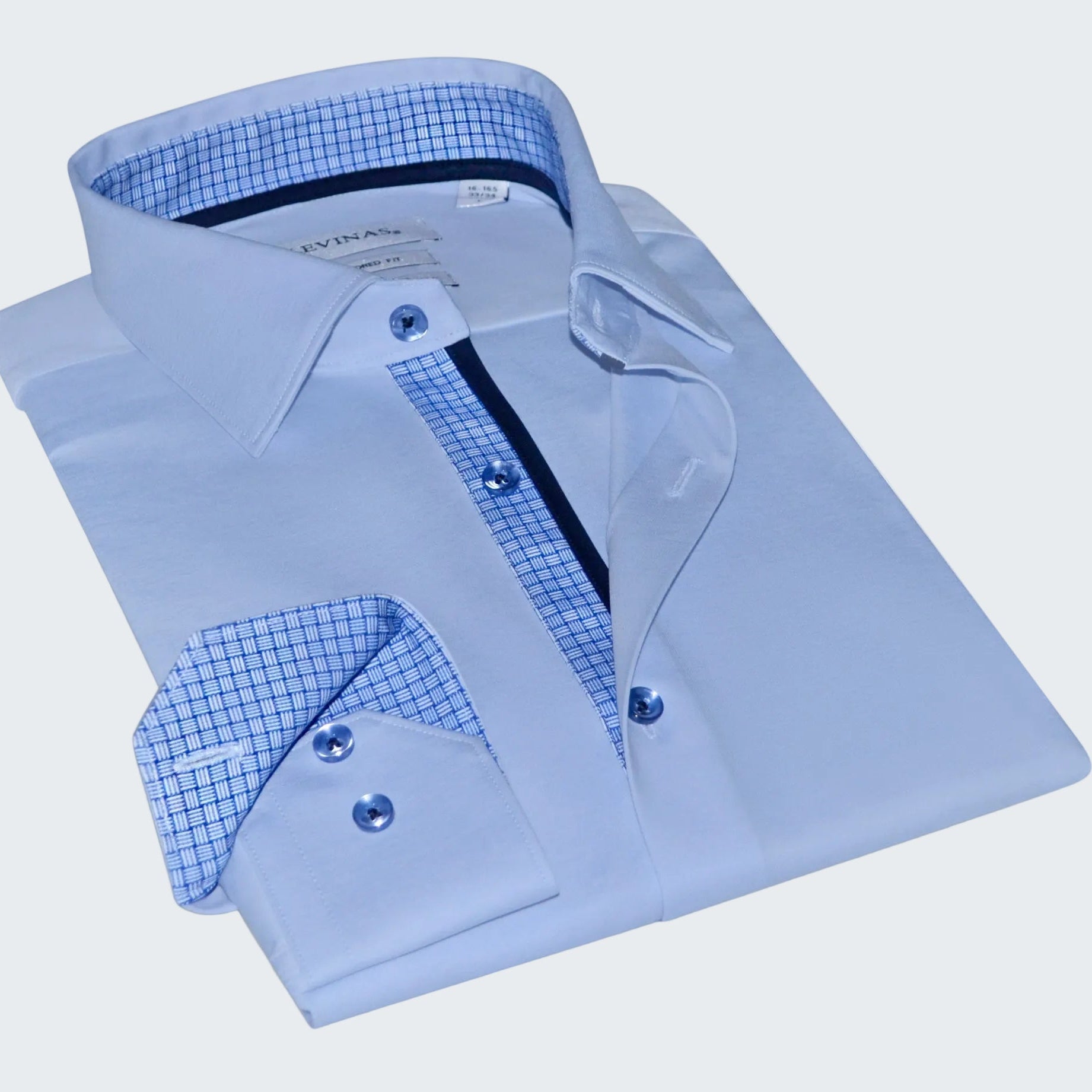 Folded light blue dress shirt with checkered interior on a white background
