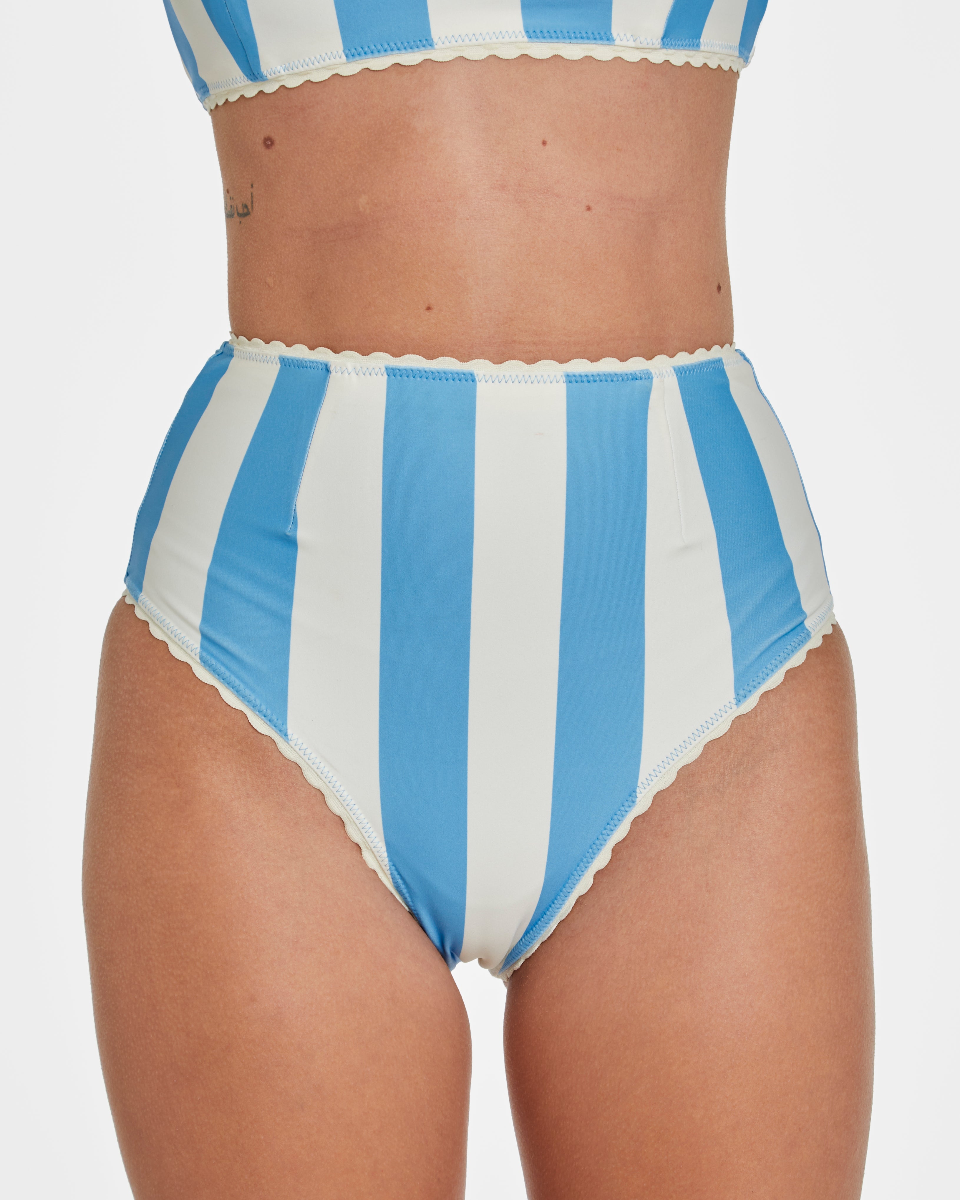Blue and white striped bikini bottom on a plain background