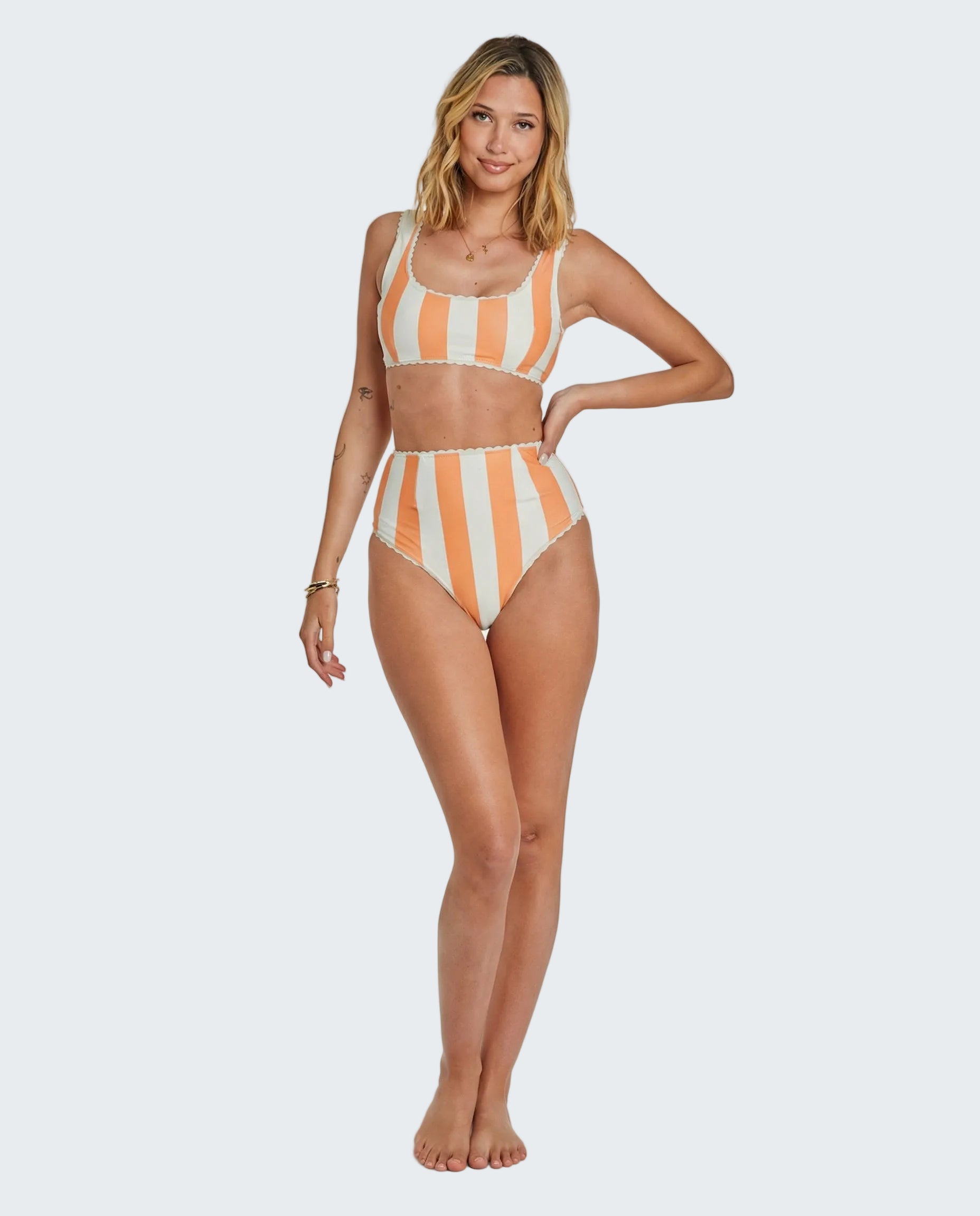 Woman wearing a striped bikini set on a white background