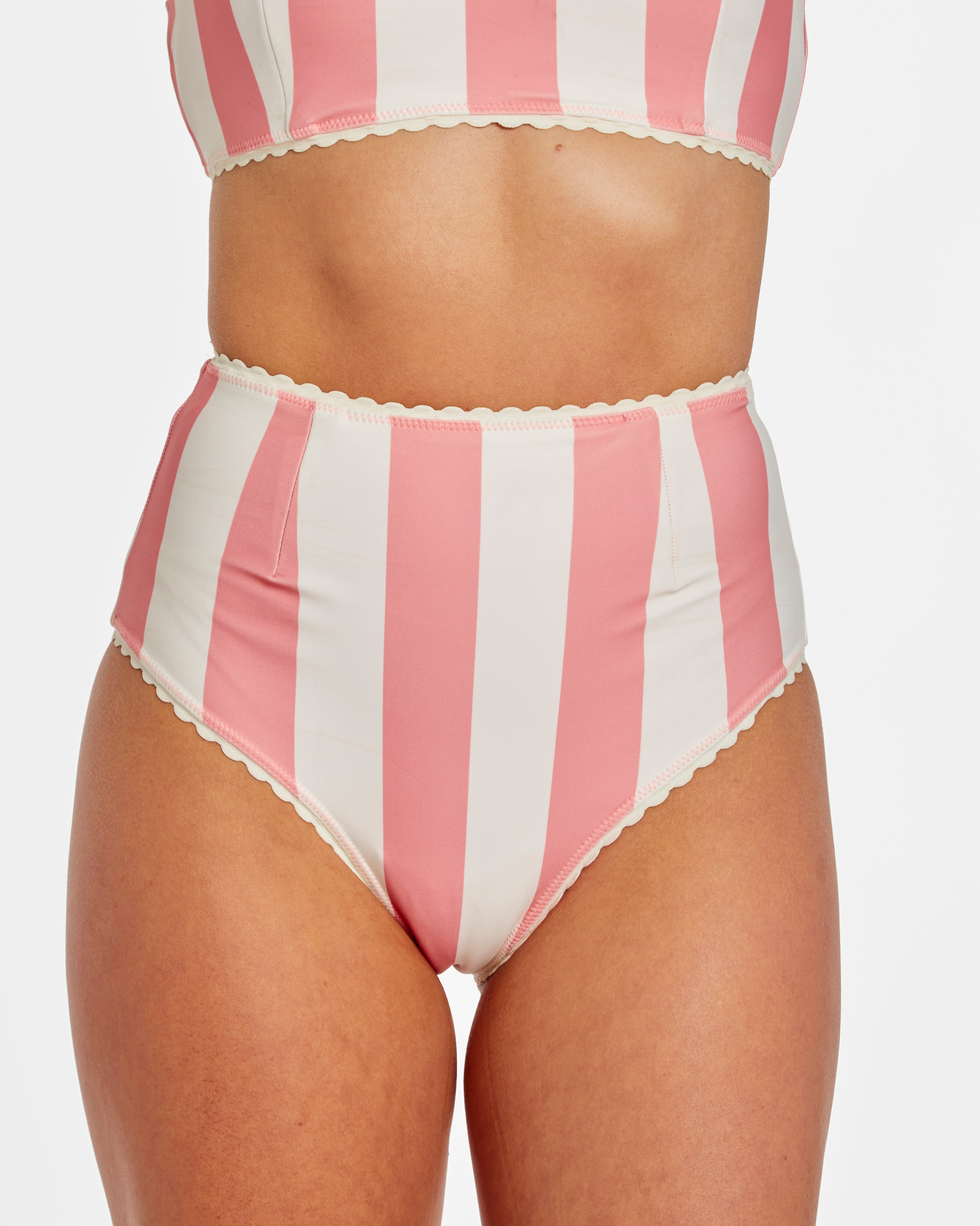 Pink and white striped swimsuit on a plain background