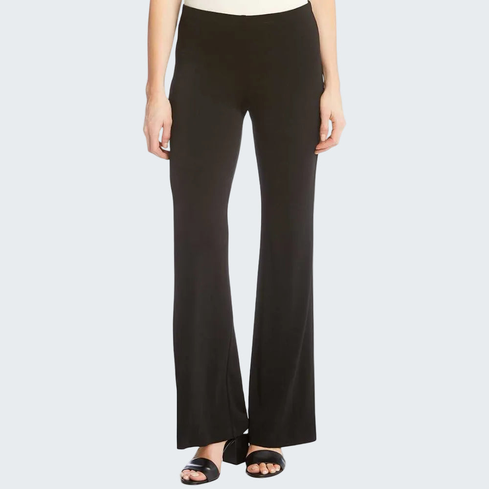 A model wearing black wide-leg pants with a straight-to-flared silhouette, paired with black slide sandals and a white top, shown against a plain white background.