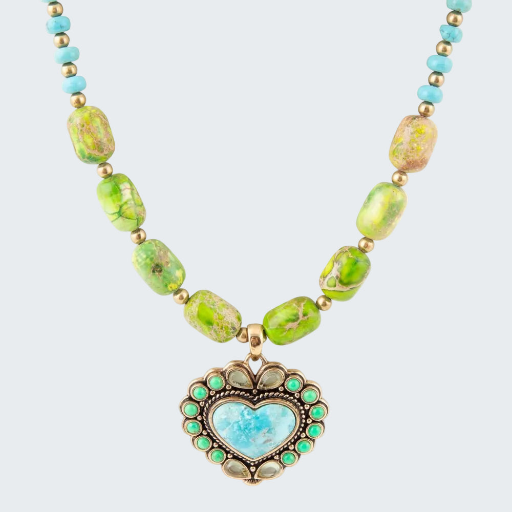 Necklace with heart-shaped pendant and green and blue beads on a white background