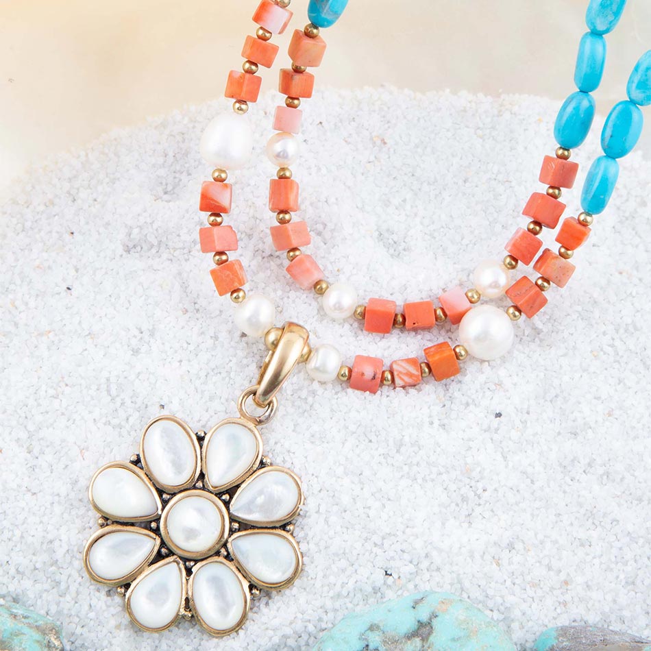 Necklace with a floral pendant on a textured surface