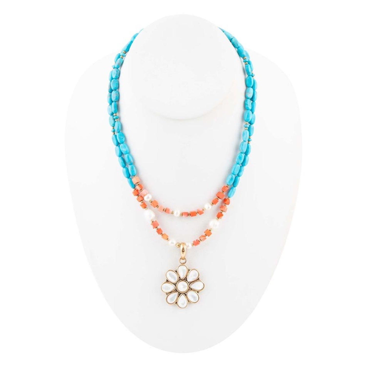Necklace with turquoise and orange beads on a white stand
