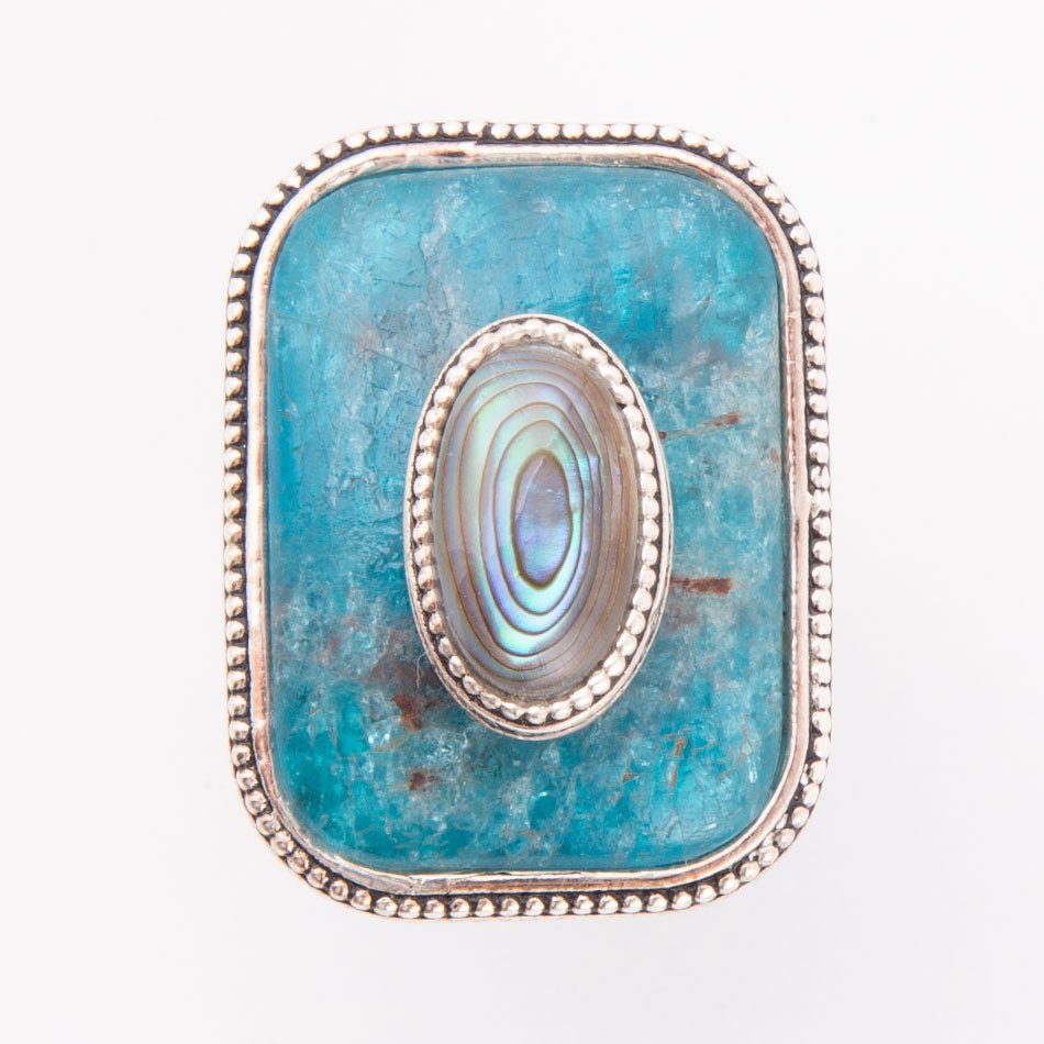 Jewelry item with blue stone and silver frame on a white background