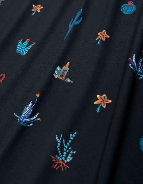Embroidered sea-themed designs on a dark fabric background