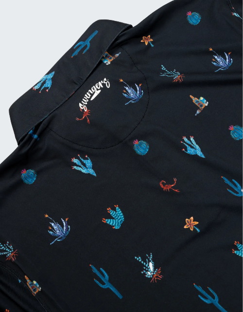 Black shirt with colorful embroidered designs on a white background