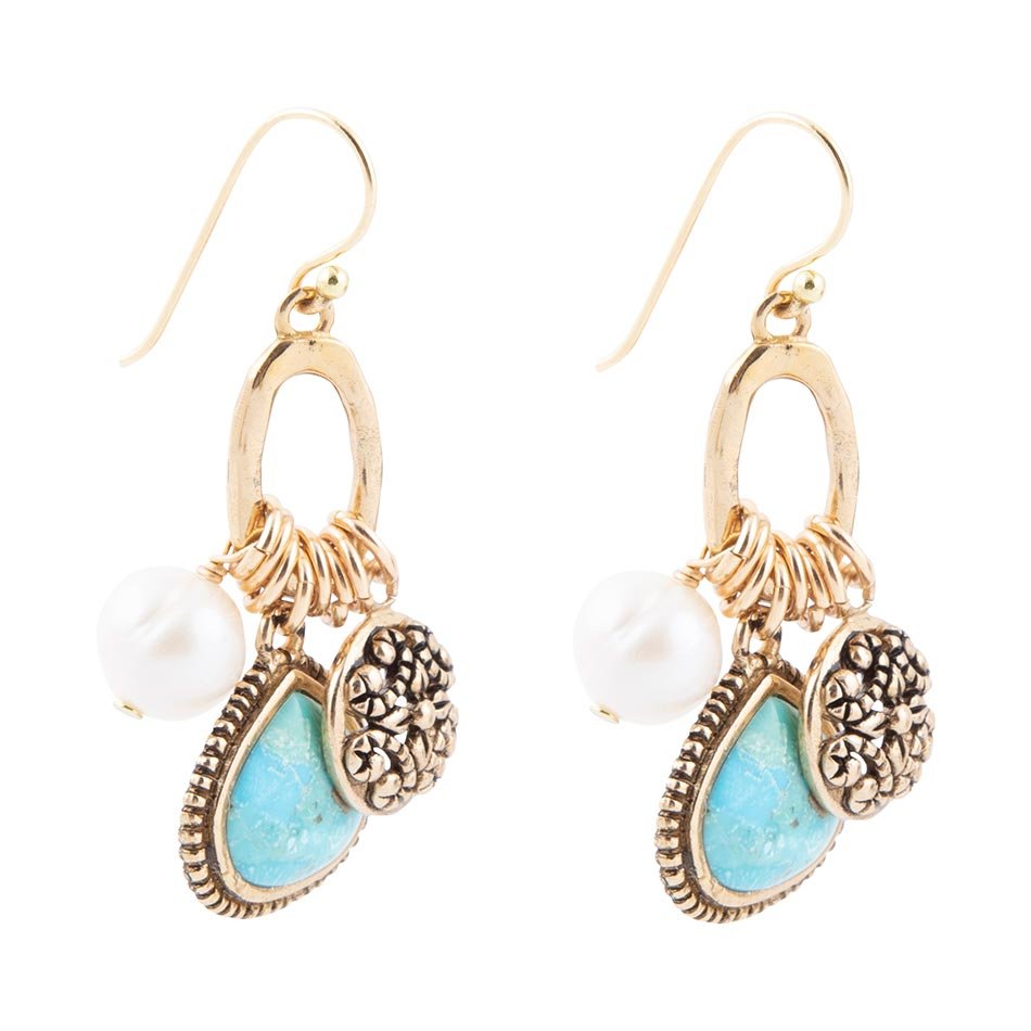 Gold earrings with turquoise stones and pearls on a white background