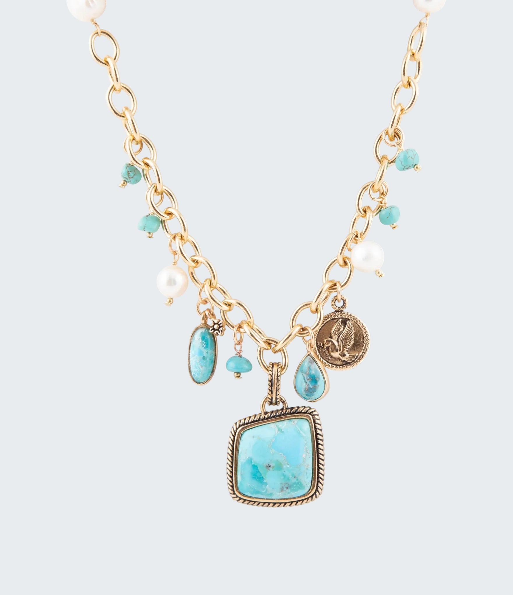Necklace with turquoise stones and gold chain on a white background