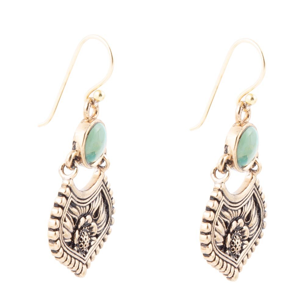 Ornate earrings with turquoise stones on a white background