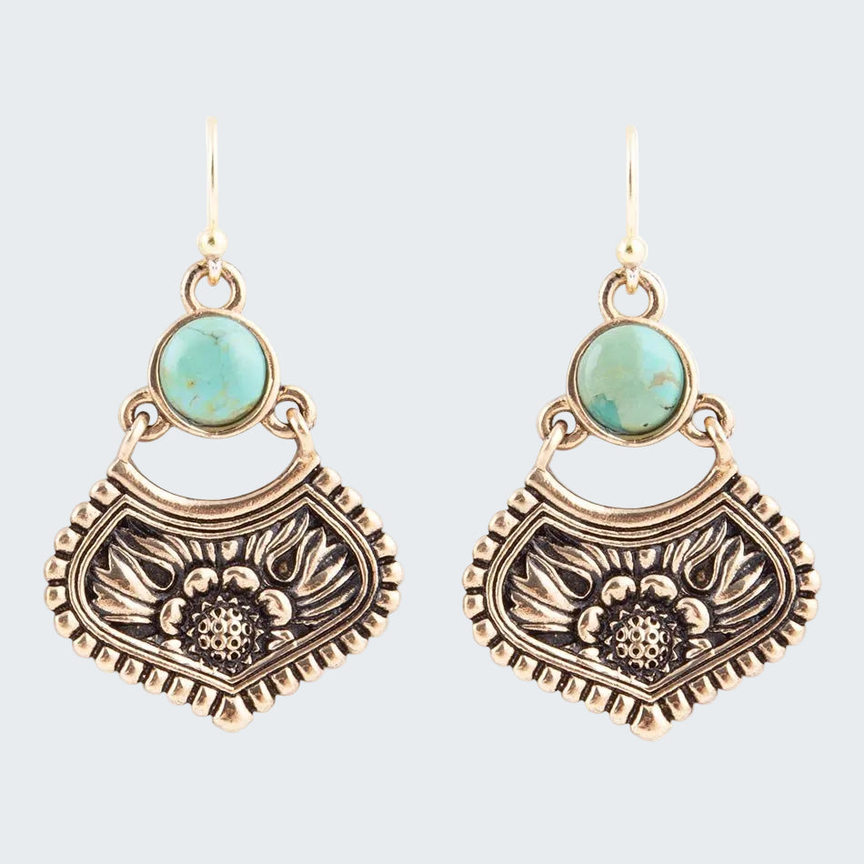 Pair of gold and turquoise earrings on a white background