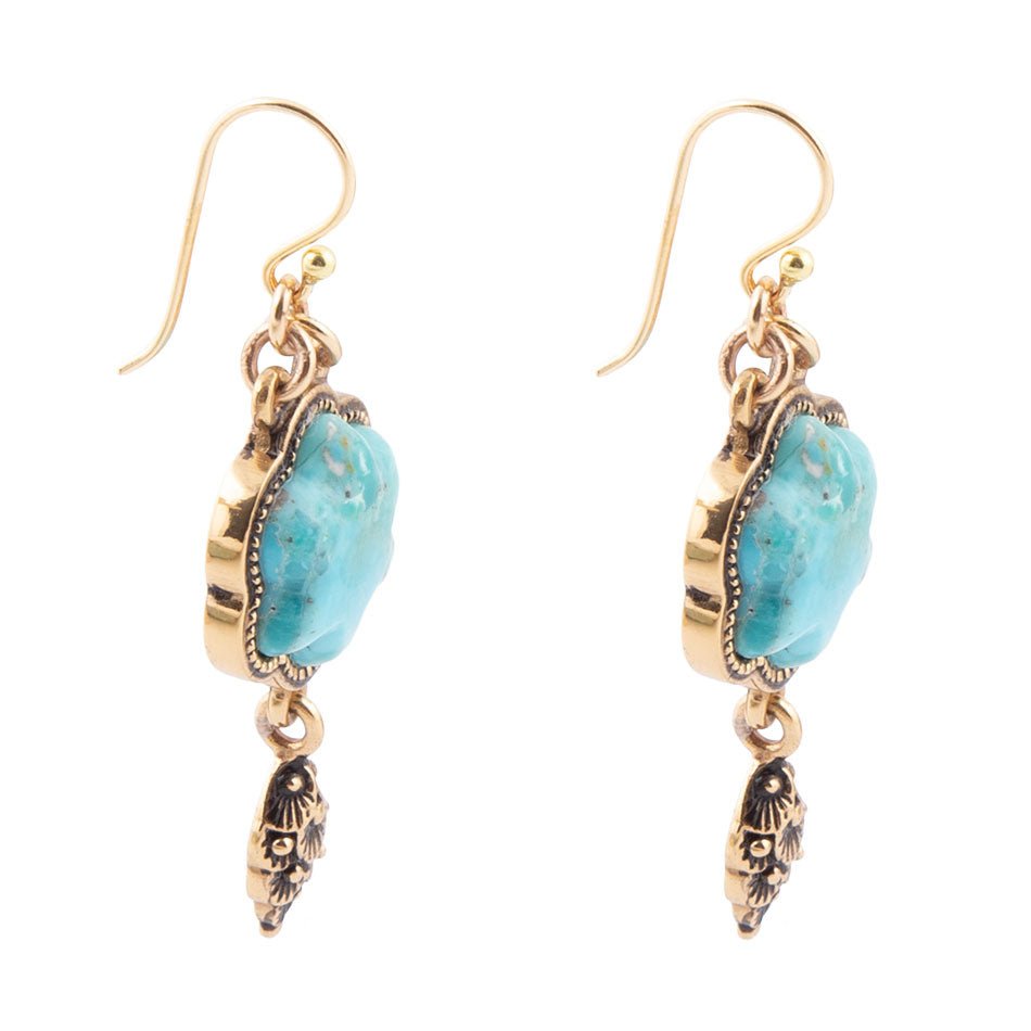 Pair of earrings with turquoise stones and gold accents on a white background
