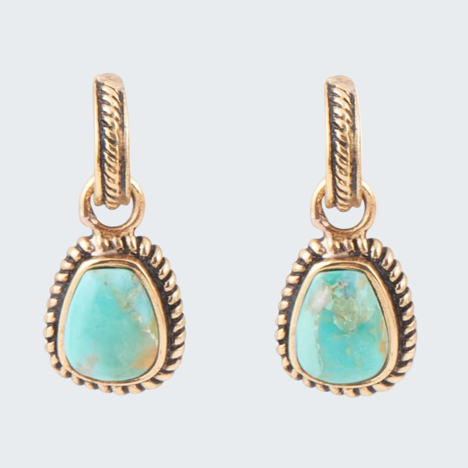 Turquoise stone pendants with gold-colored settings on a white background