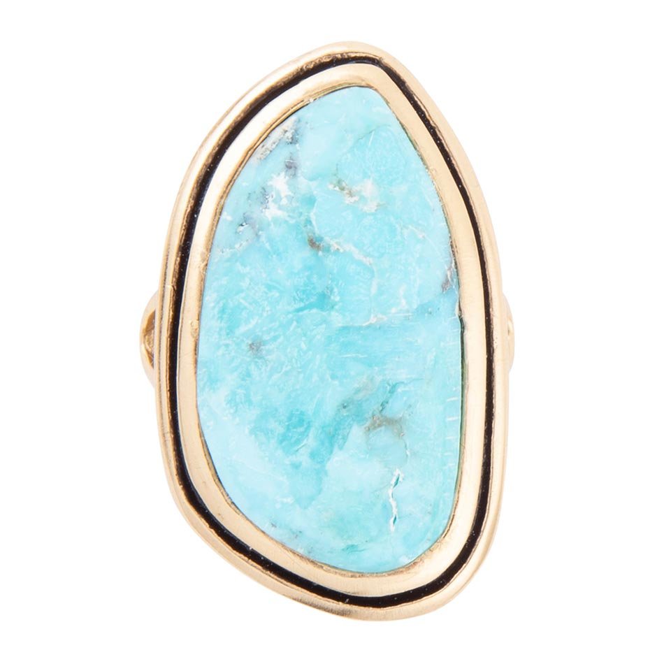 Ring with turquoise stone and gold band on a white background