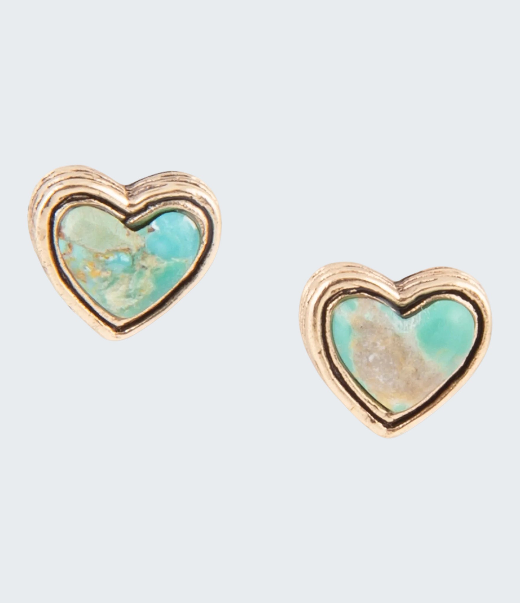 Heart-shaped earrings with turquoise center and gold border on a white background