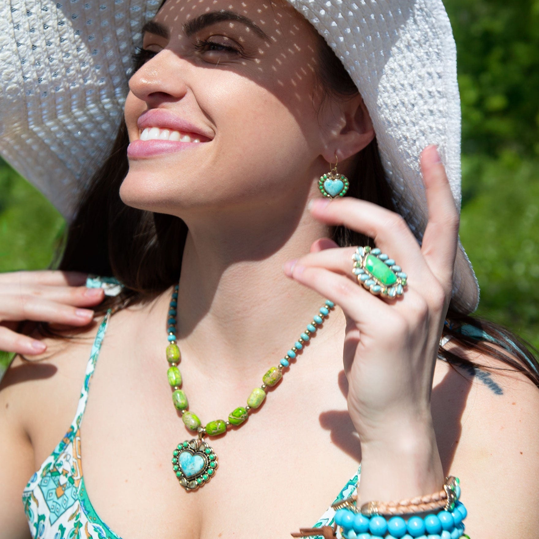 Woman wearing turquoise and green jewelry outdoors