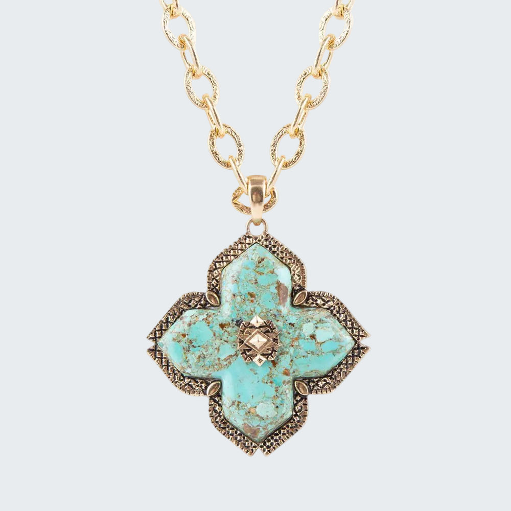 Turquoise floral pendant necklace on a gold chain against a white background