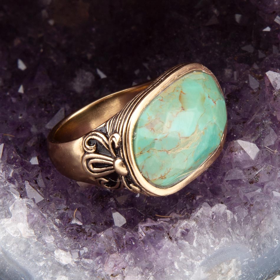 Gold ring with turquoise stone on a crystal background