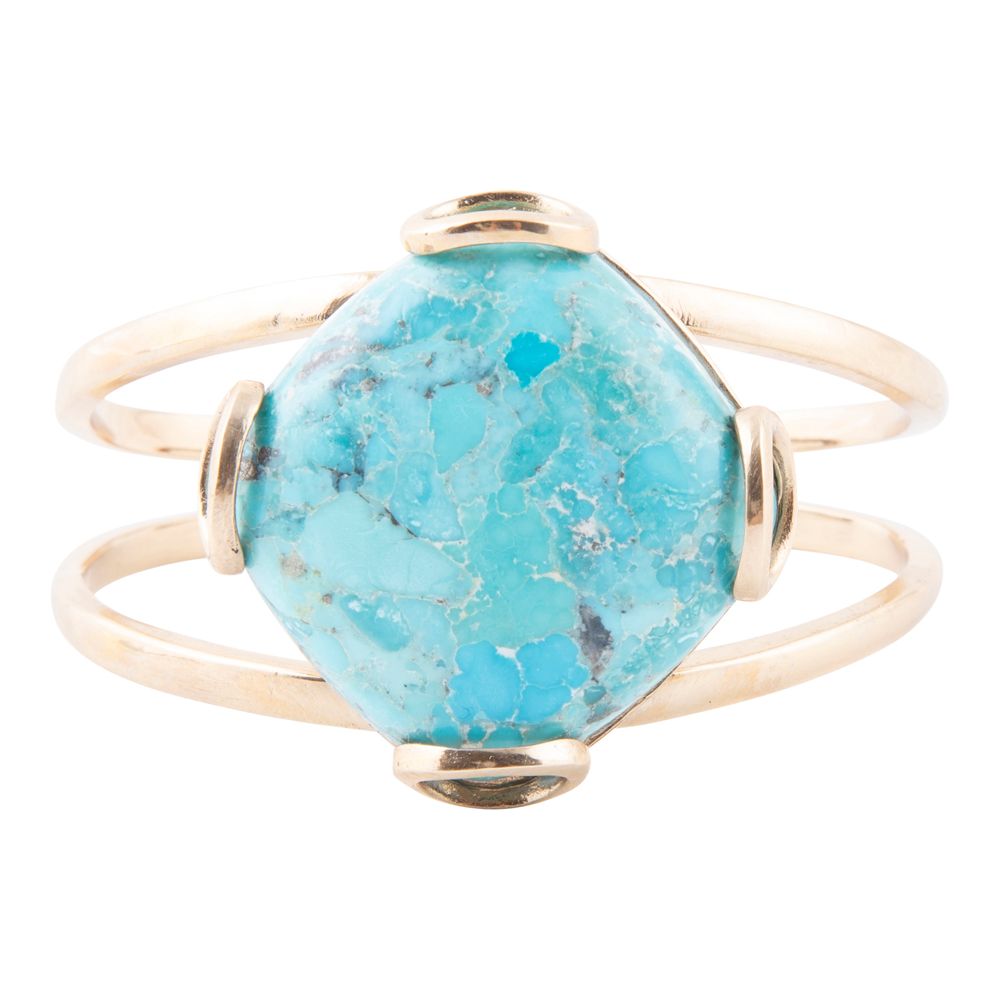 Turquoise stone ring with gold band on a white background
