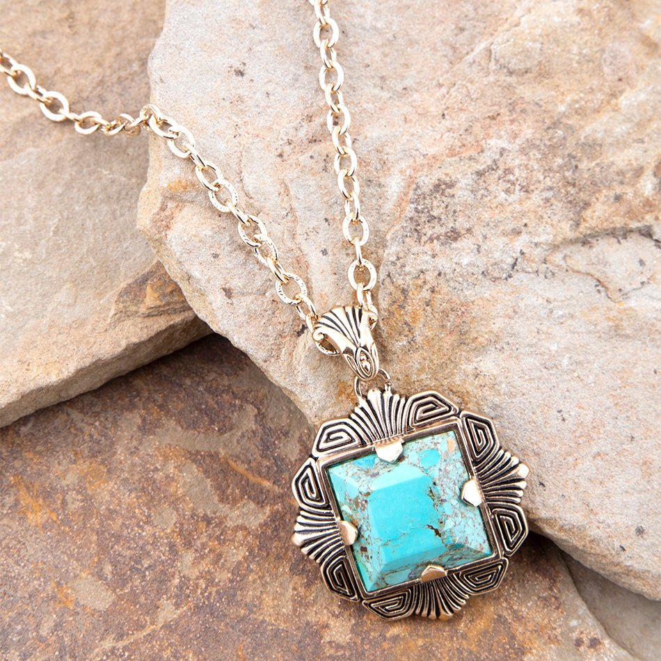 Turquoise pendant necklace on a stone surface