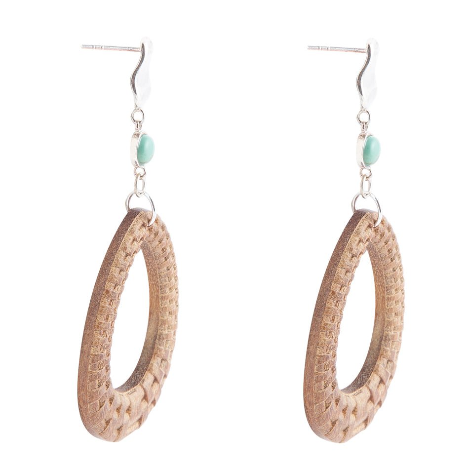 Pair of hoop earrings with textured design and small beads on a white background