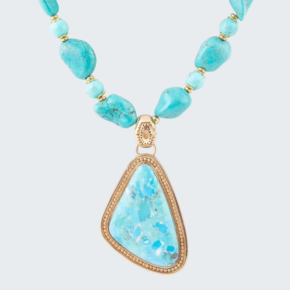 Turquoise necklace with a gold pendant on a white background