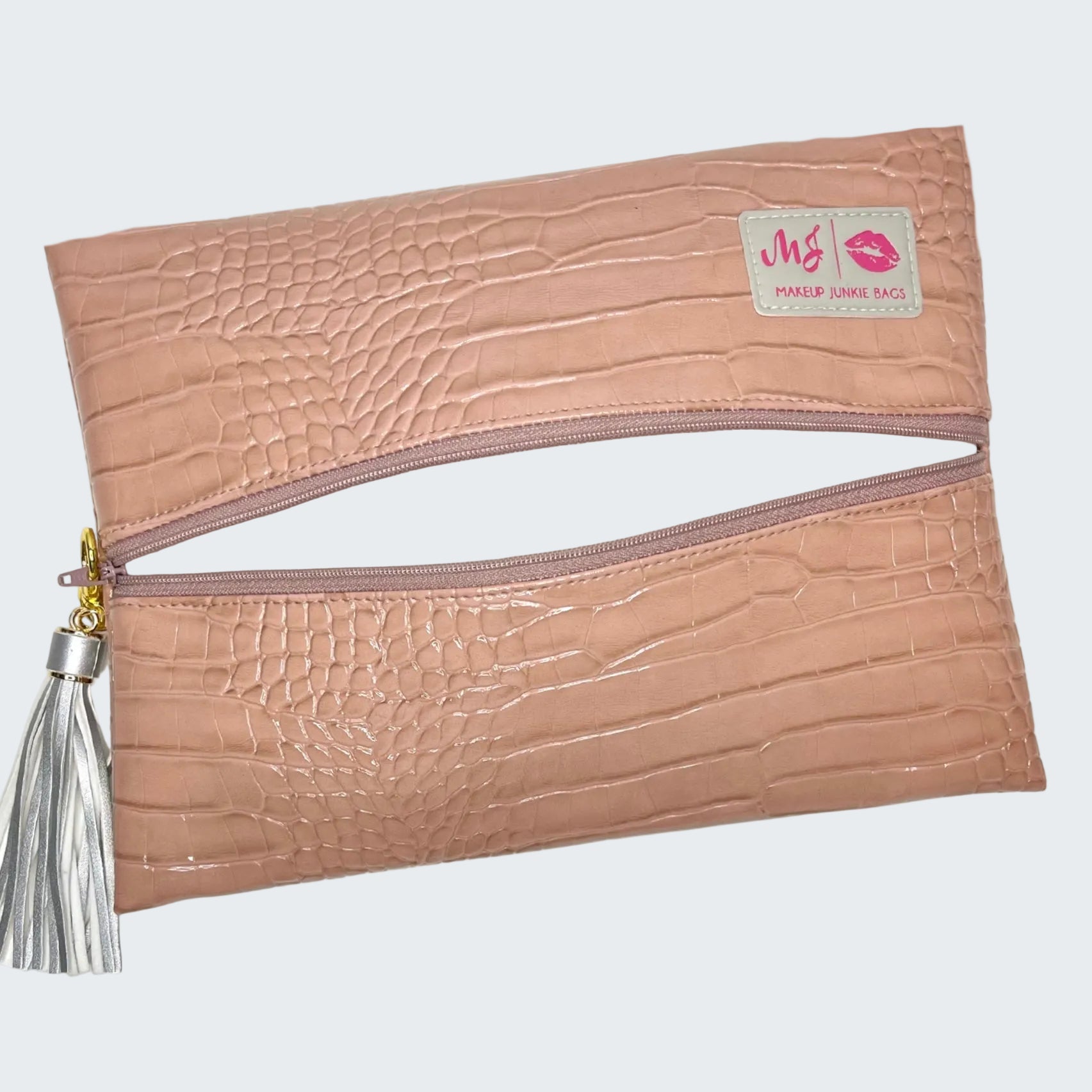 Pink textured clutch bag with a tassel on a white background