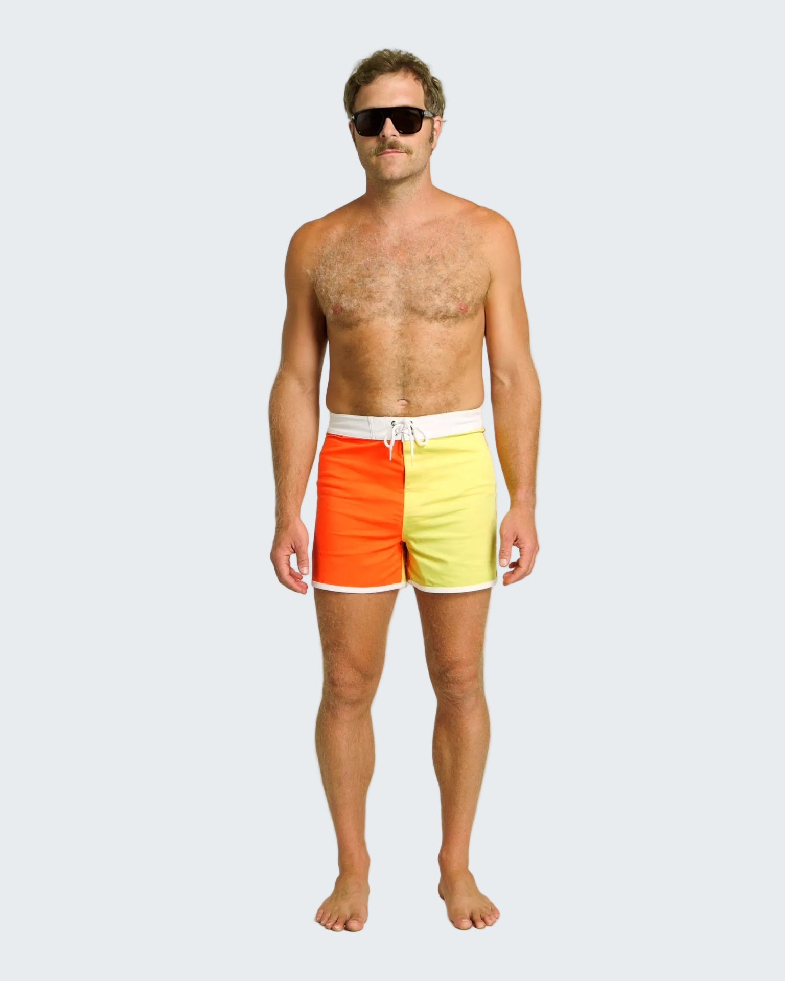 Man wearing a colorful two-tone swimsuit on a white background