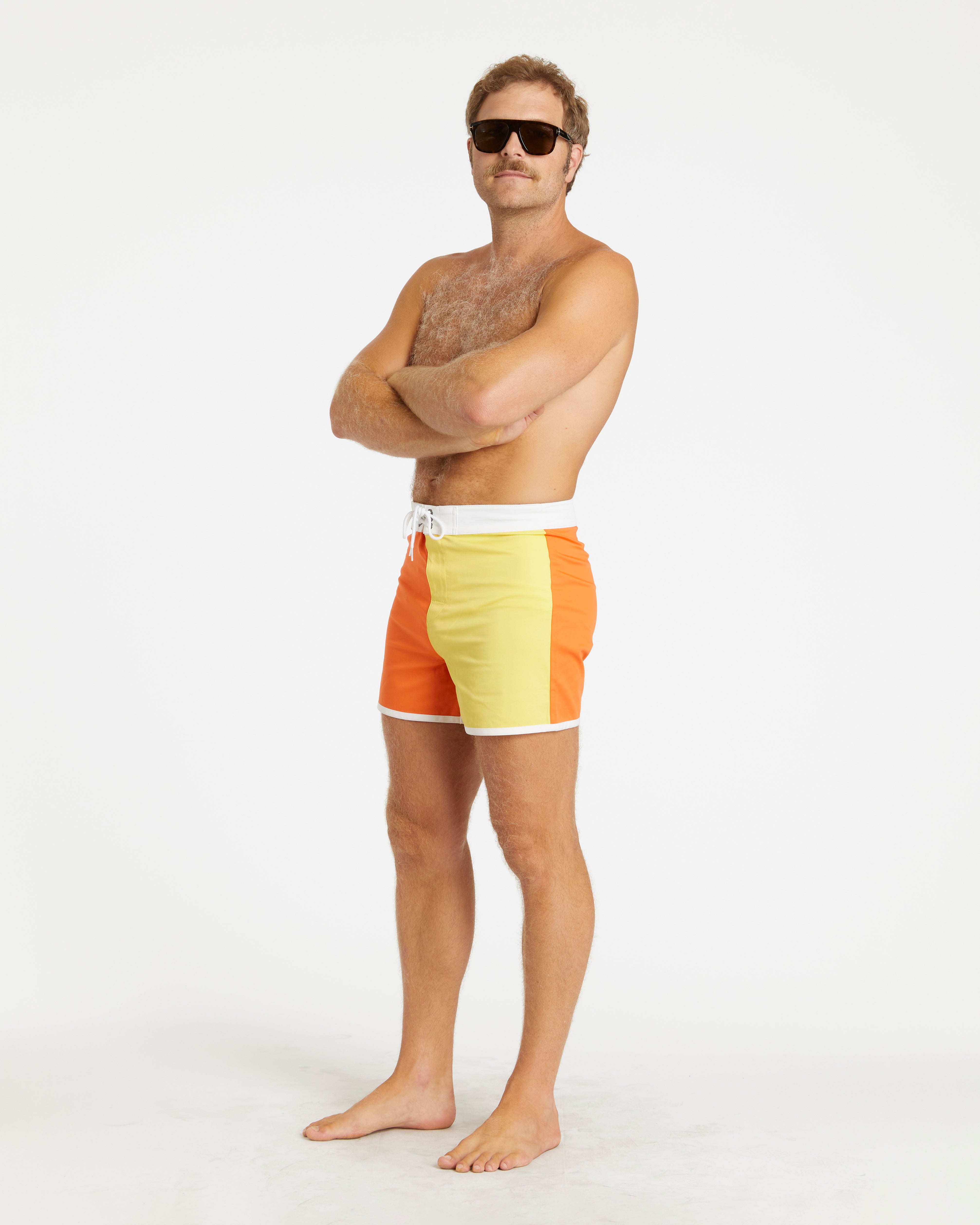 Man wearing colorful swim shorts on a white background