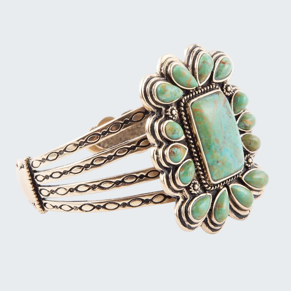 Turquoise stone bracelet with silver detailing on a white background