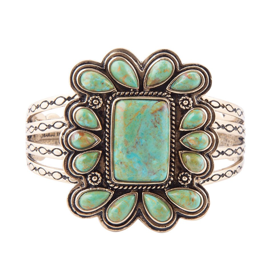 Turquoise stone bracelet with silver detailing on a white background