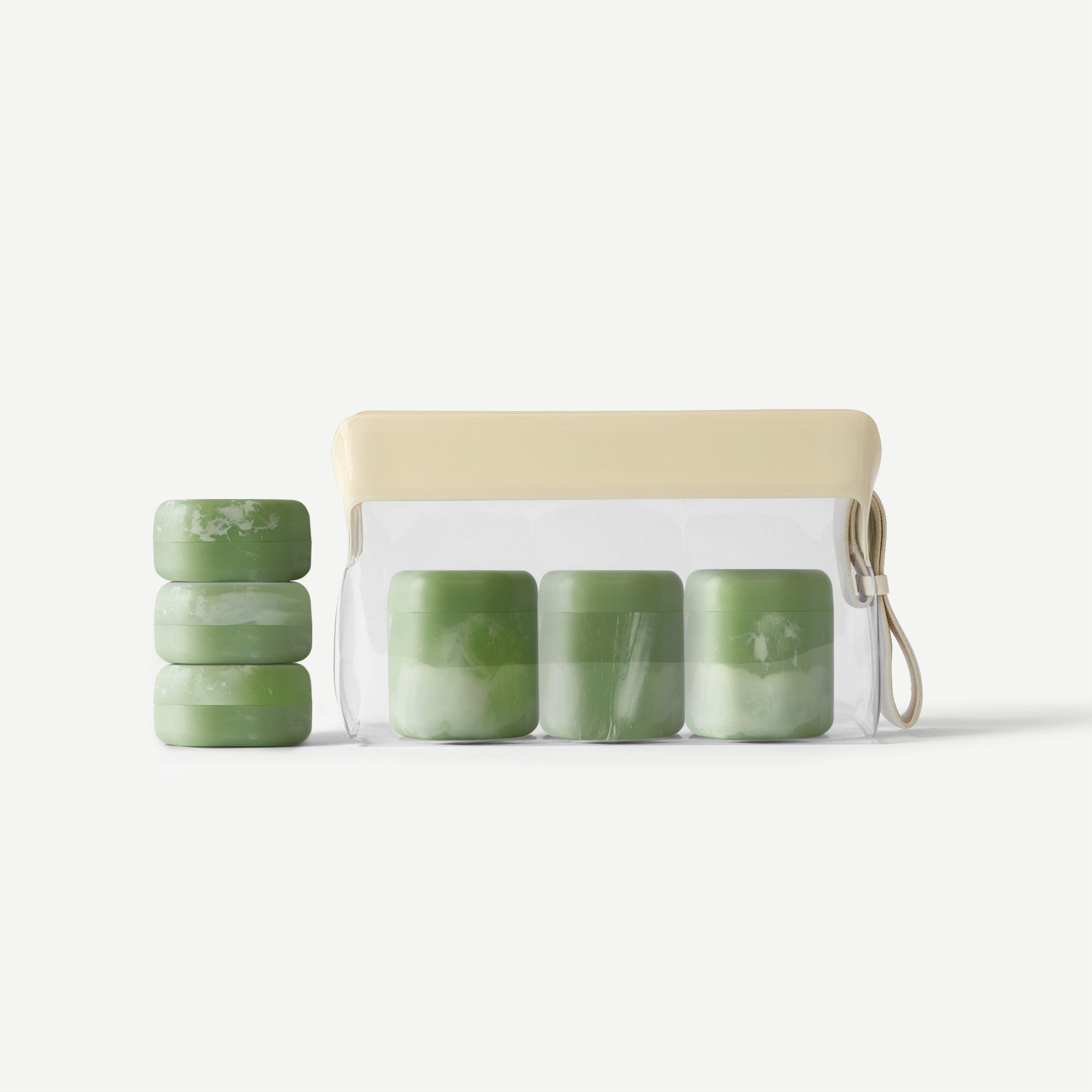 Set of green containers with a beige pouch on a white background